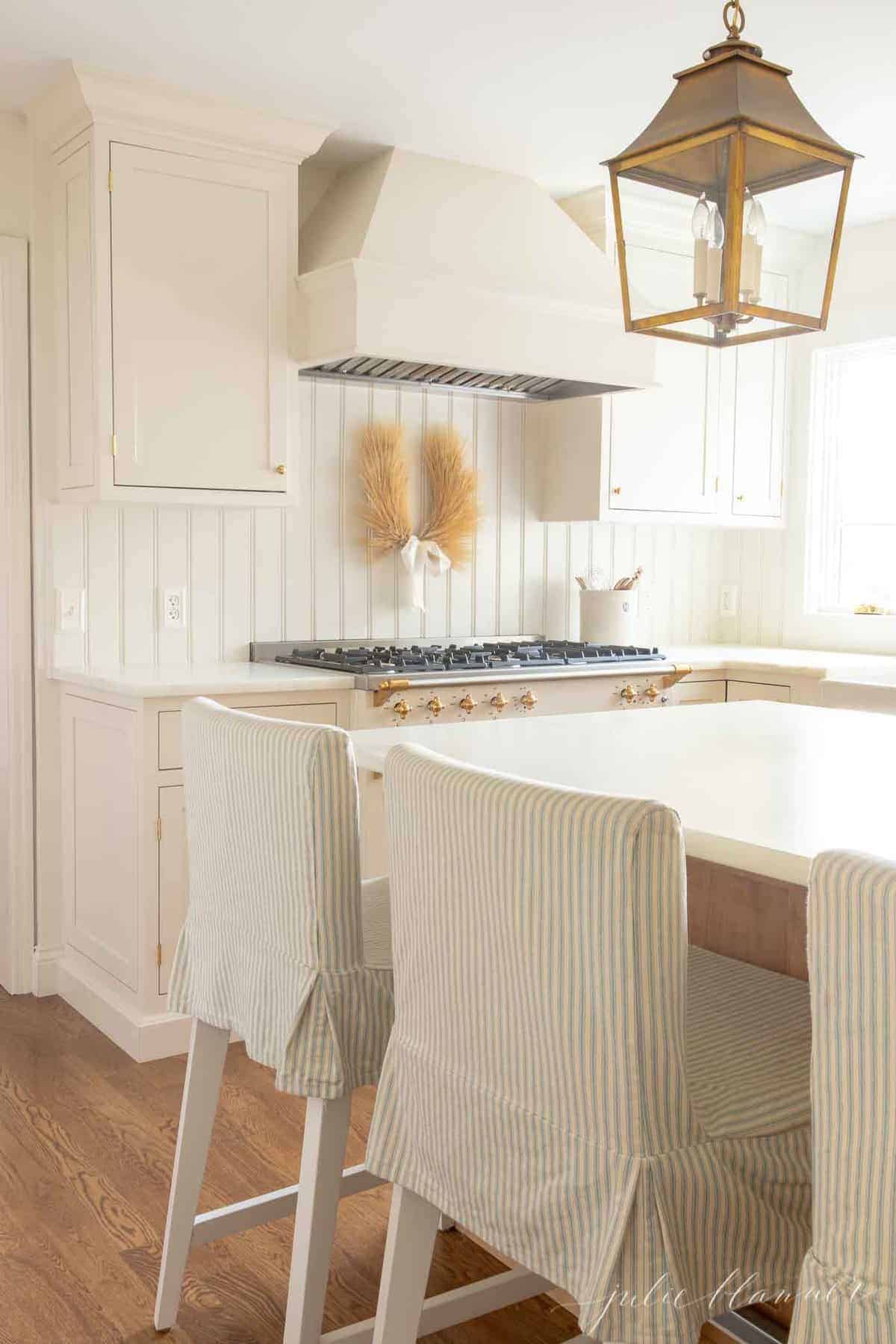 A white and wood kitchen with white beadboard.