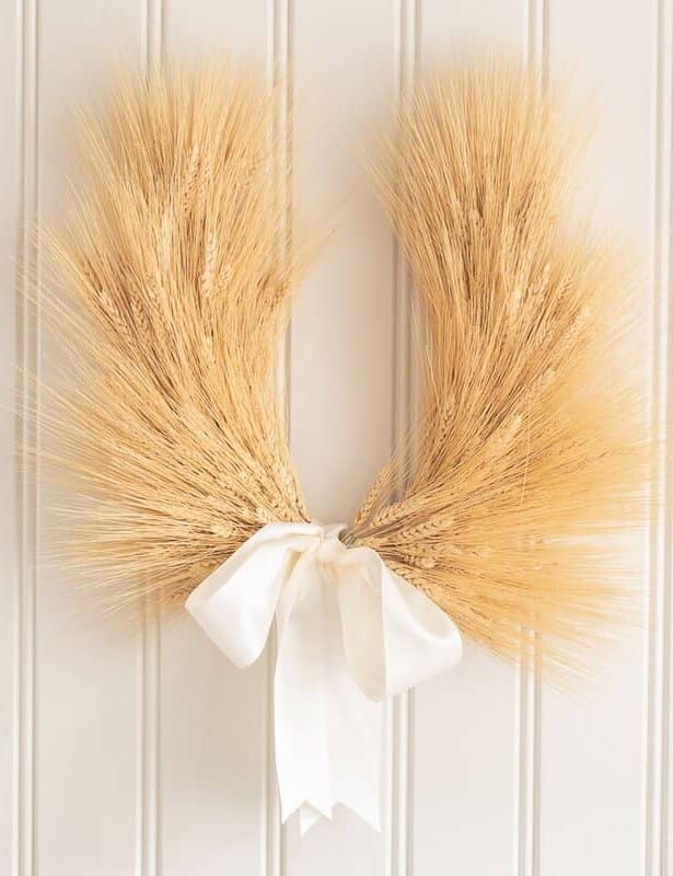 A wheat wreath on a beadboard background.