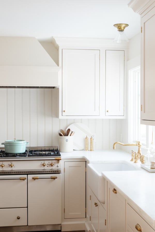 A white kitchen with a beadboard backsplash
