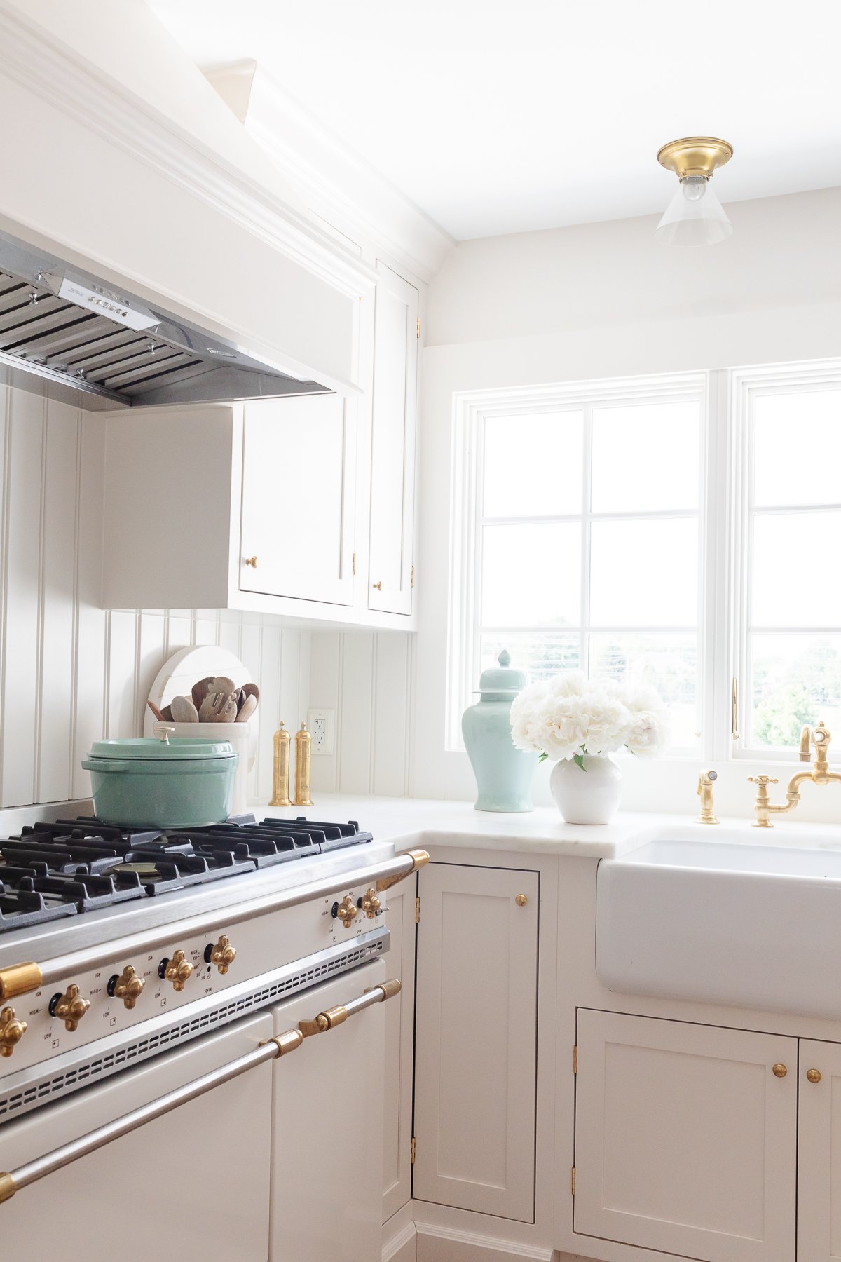 A white kitchen with a beadboard backsplash