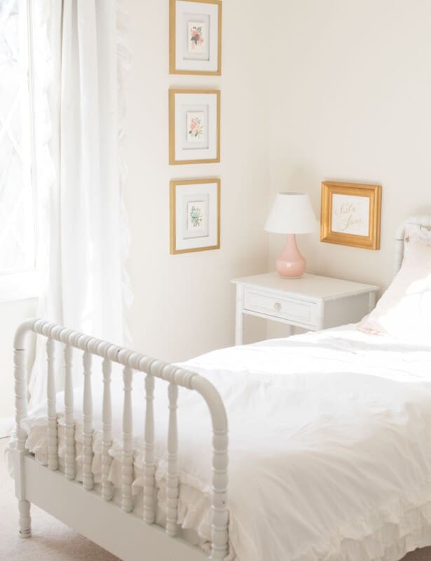 A white bedroom A living room with white furniture with a cream eggshell paint on the walls.