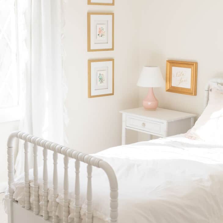 A white bedroom A living room with white furniture with a cream eggshell paint on the walls.