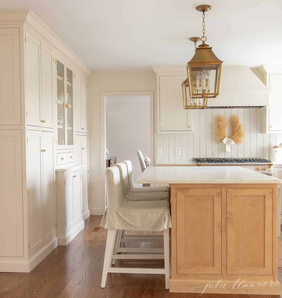 A white and wood kitchen with white beadboard.