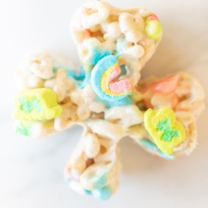 Lucky charm bars cut into clovers and placed on a marble countertop.