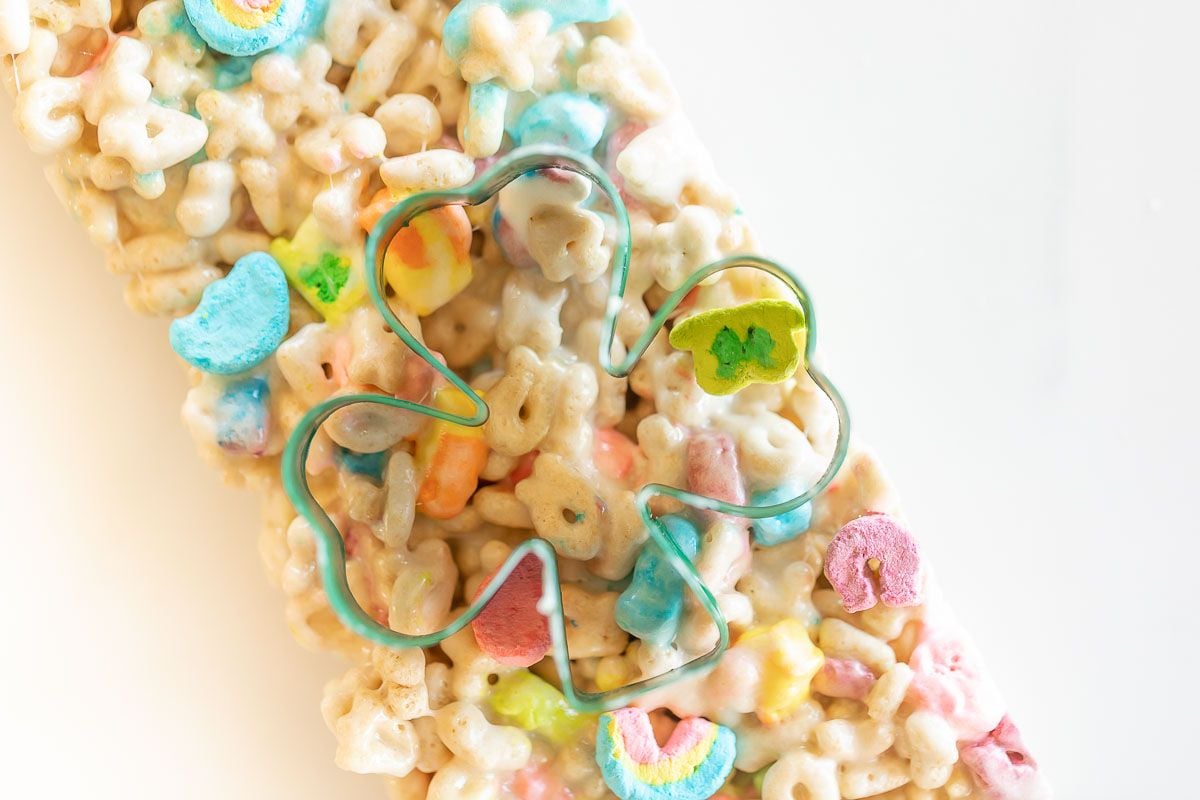 Lucky charm bars cut into clovers and placed on a marble countertop.