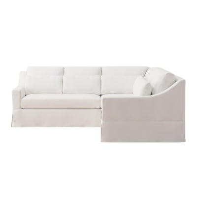A white sectional sofa against a white background.