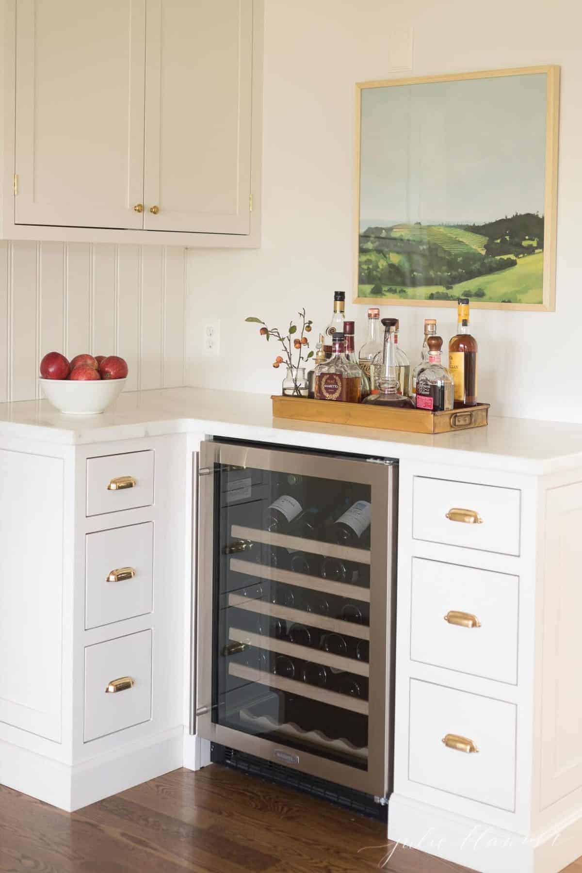 A wine bar area in a kitchen featuring shaker cabinet doors and flat drawer fronts.