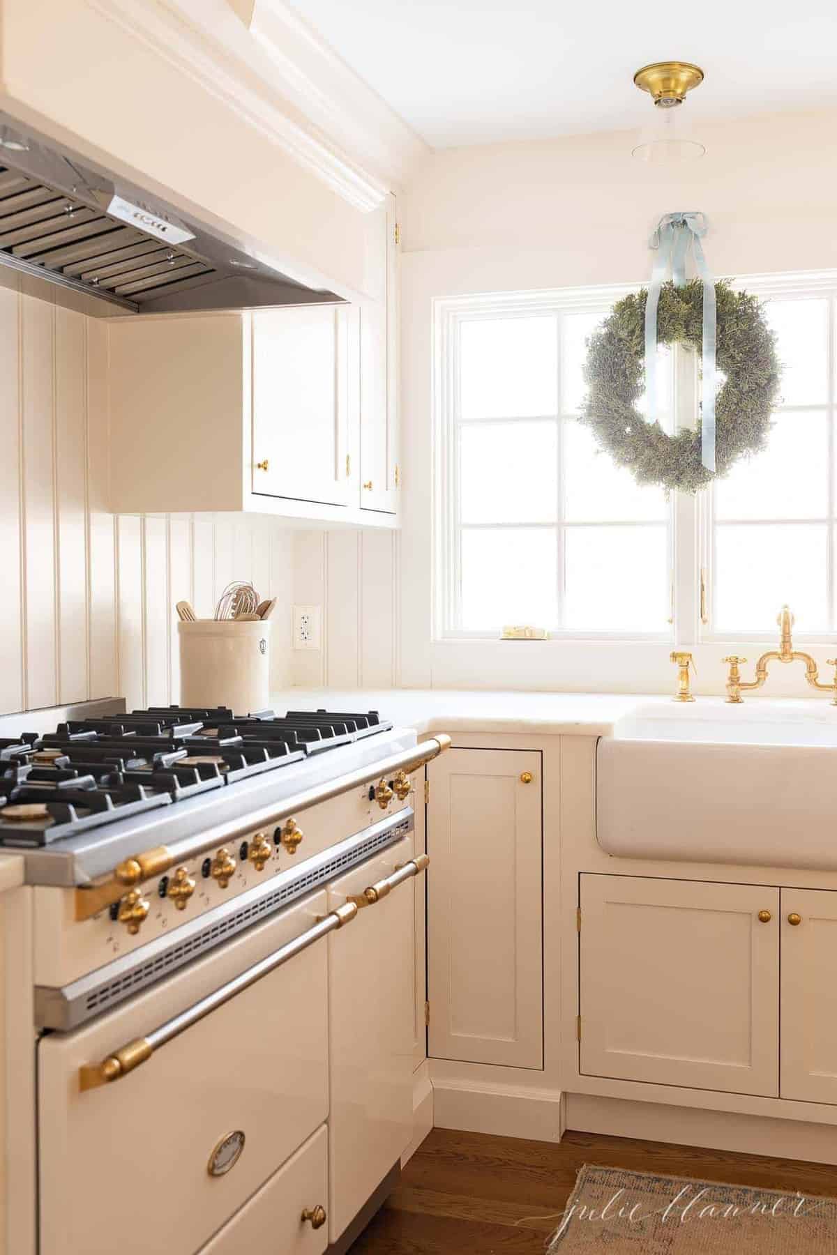 A white kitchen with shaker style kitchen cabinets.
