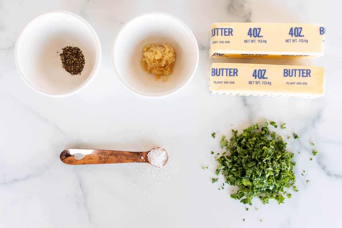 herbs, spices and butter on marble surface