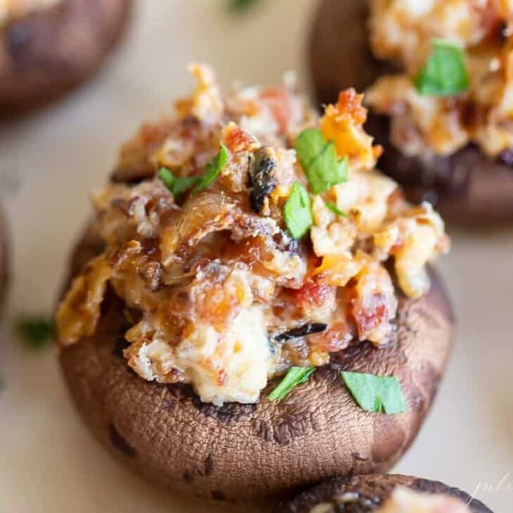 Stuffed mushrooms on a white platter in a Super Bowl game day round up