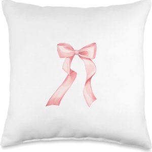 A white pillow with a pink bow, perfect for a tween girl bedroom.