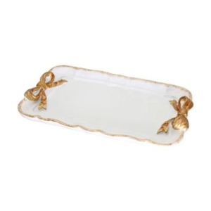 A white and gold plate adorned with gold bows, perfect for a tween girl bedroom.