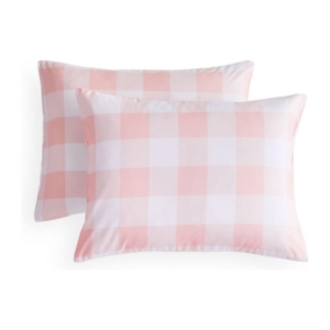 Two pink and white gingham pillows in a tween girl bedroom.