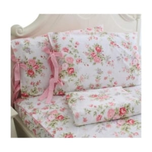 A bed with a pink and white floral pattern is perfect for a tween girl bedroom.