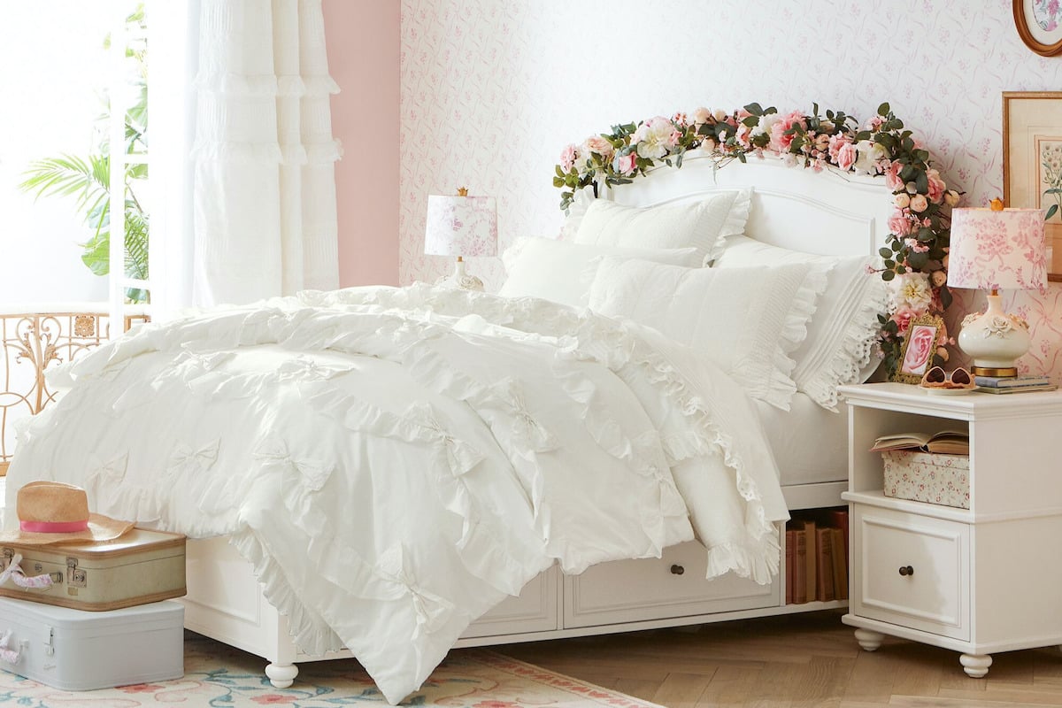 A white bed with ruffles in a pink bedroom provides a coquette touch perfect for tween bedroom ideas.