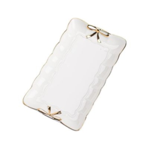 A white rectangular plate adorned with gold bows, perfect for a tween girl bedroom.