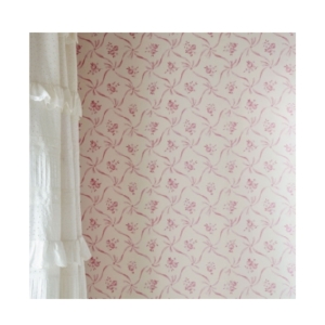 A coquette-inspired pink and white wallpaper adds a touch of charm to your tween bedroom.