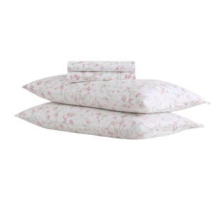 A white sheet set with pink flowers on it, perfect for a tween girl bedroom.