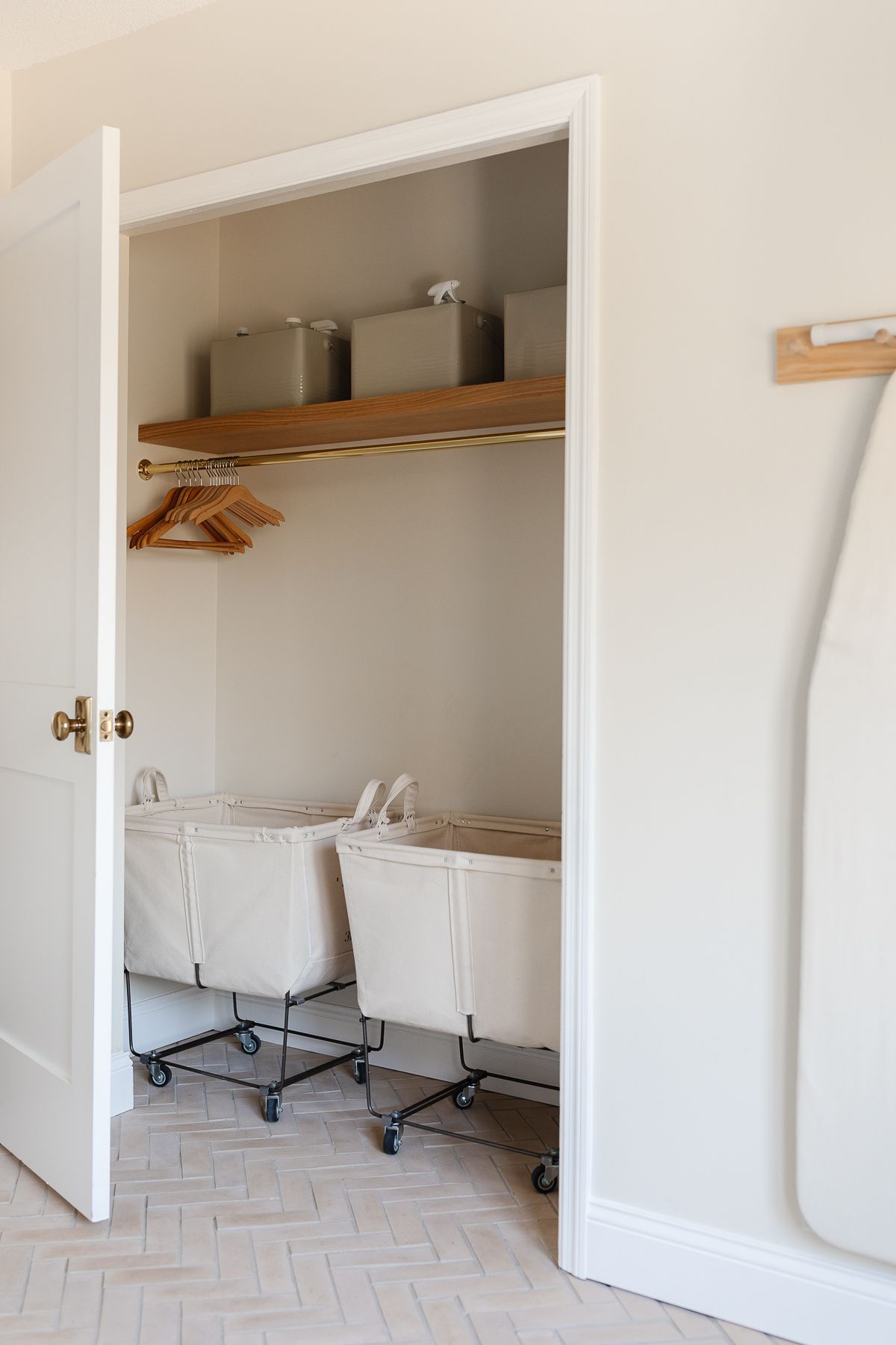 The closet of a modern laundry room with rolling laundry baskets
