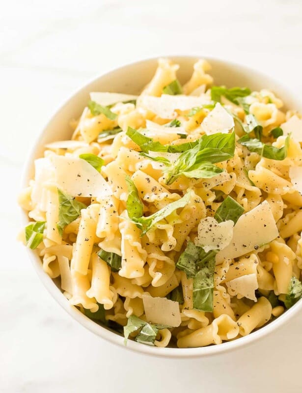 pasta salad topped with basil parmesan and pine nuts