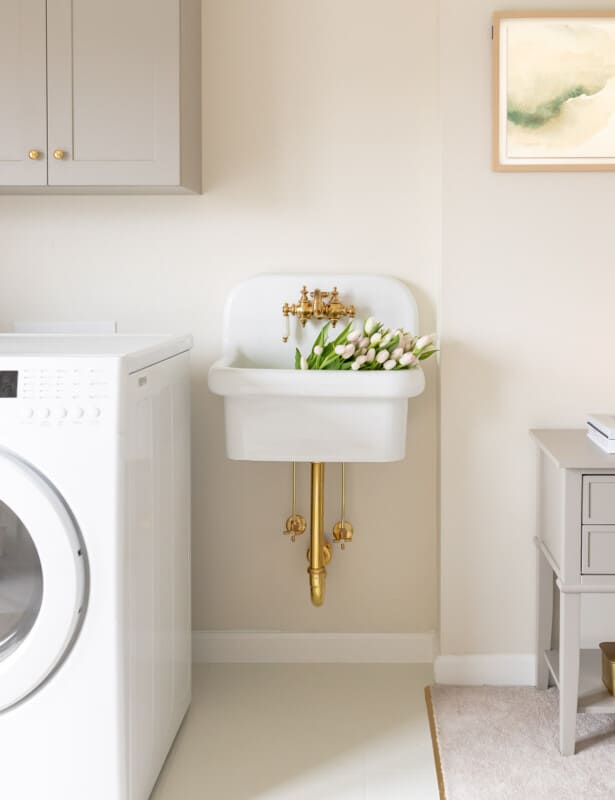 cream and gray laundry room with painted linoleum floor