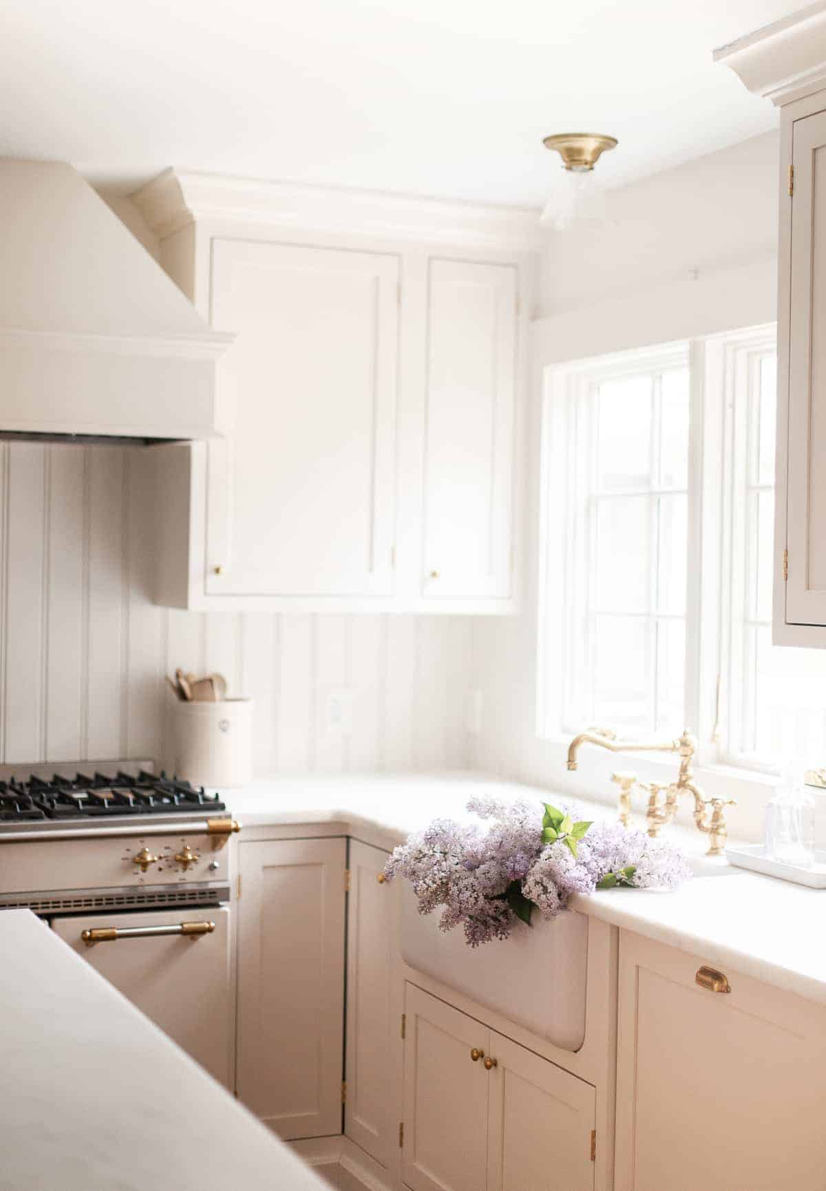 kitchen with walls and trim painted in the same color and flowers in the sink