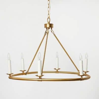 A circular brass chandelier on white background