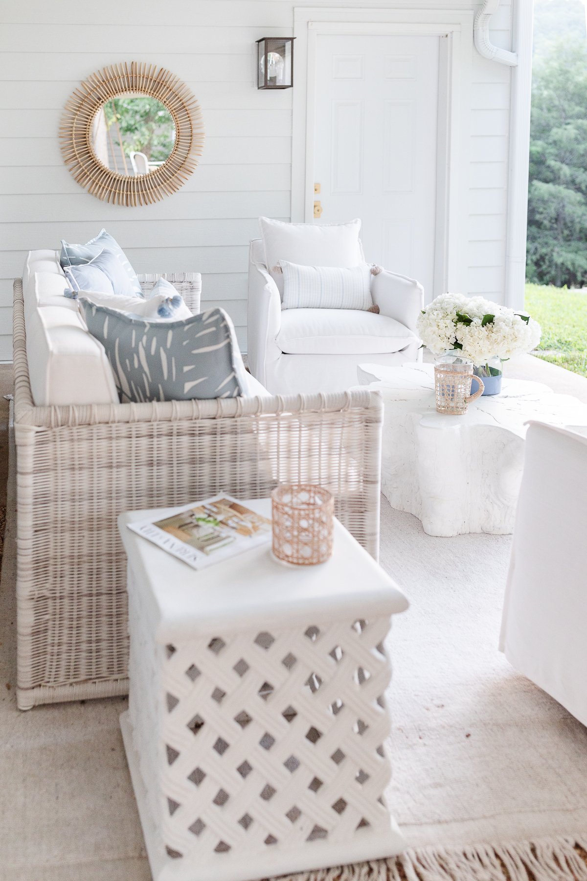 A white living room with wicker furniture.