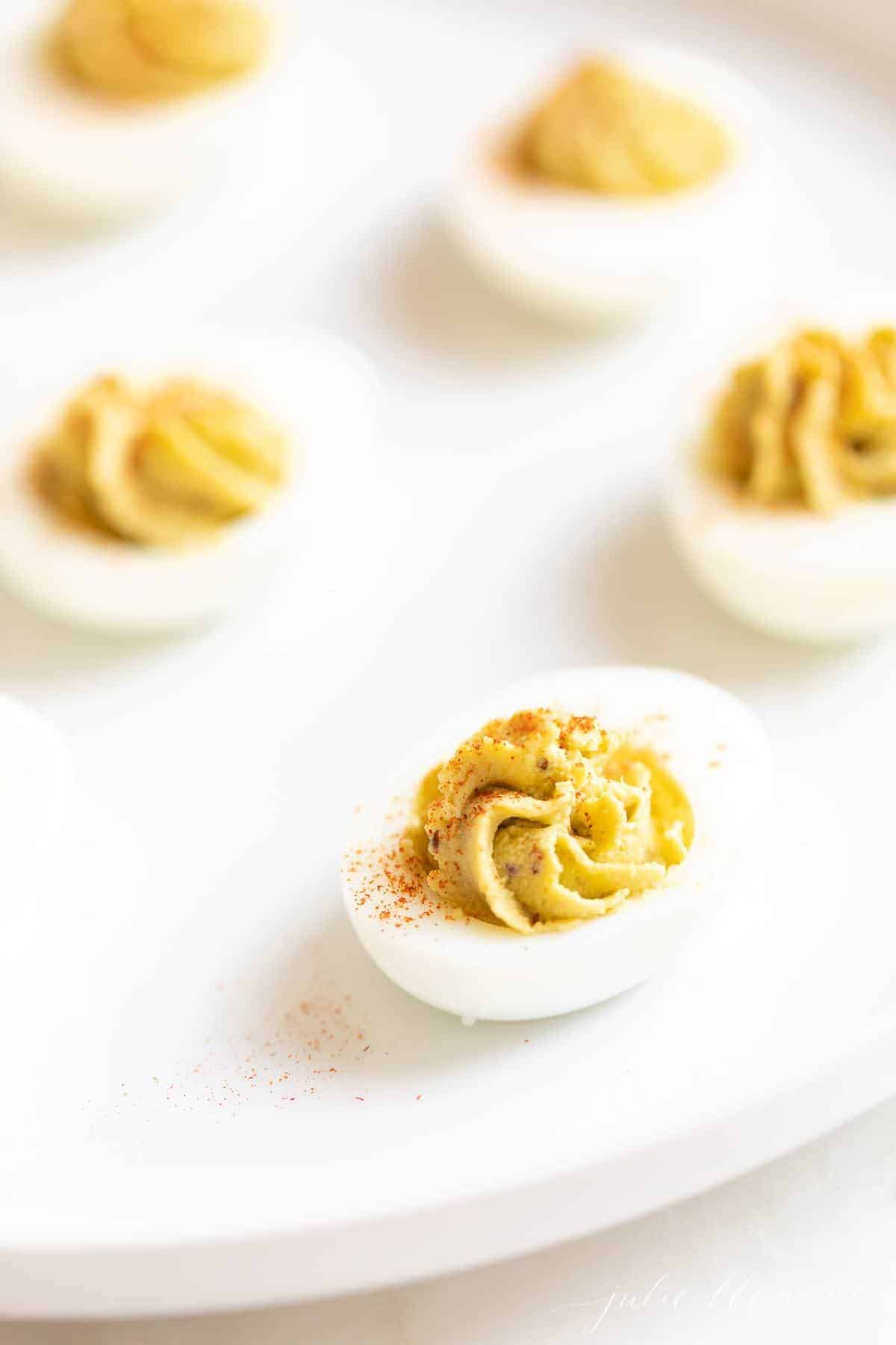 avocado deviled eggs on a white plate for a healthy appetizer