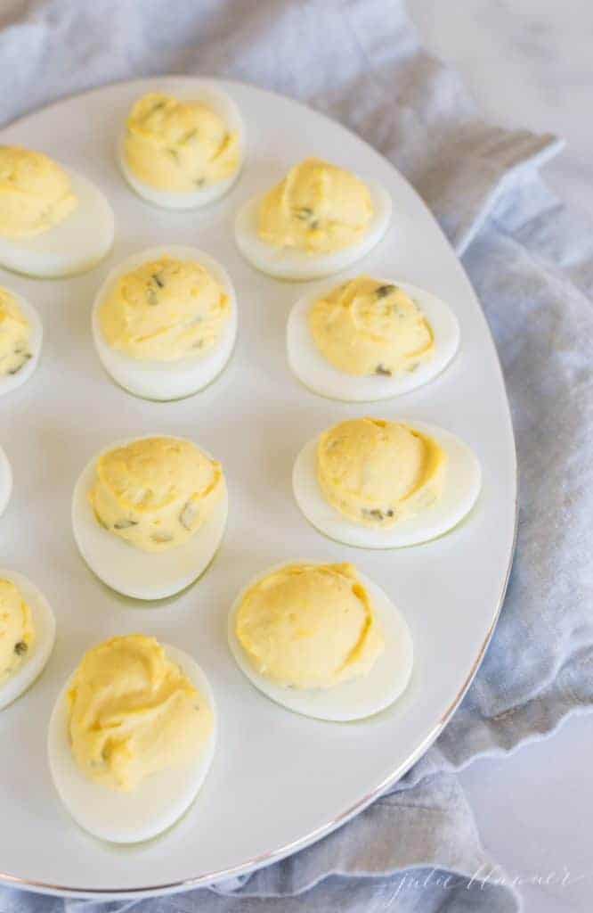 deviled eggs on a white oval platter