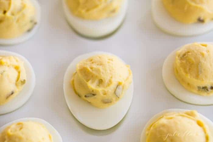 deviled eggs on a white platter