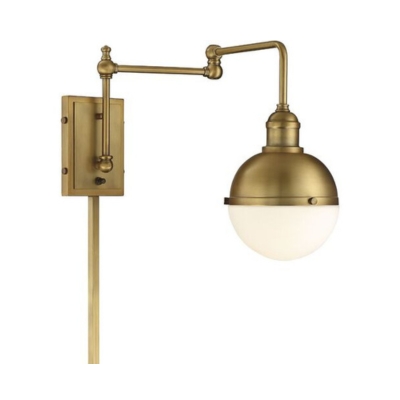 A brass wall sconce with a rotating arm