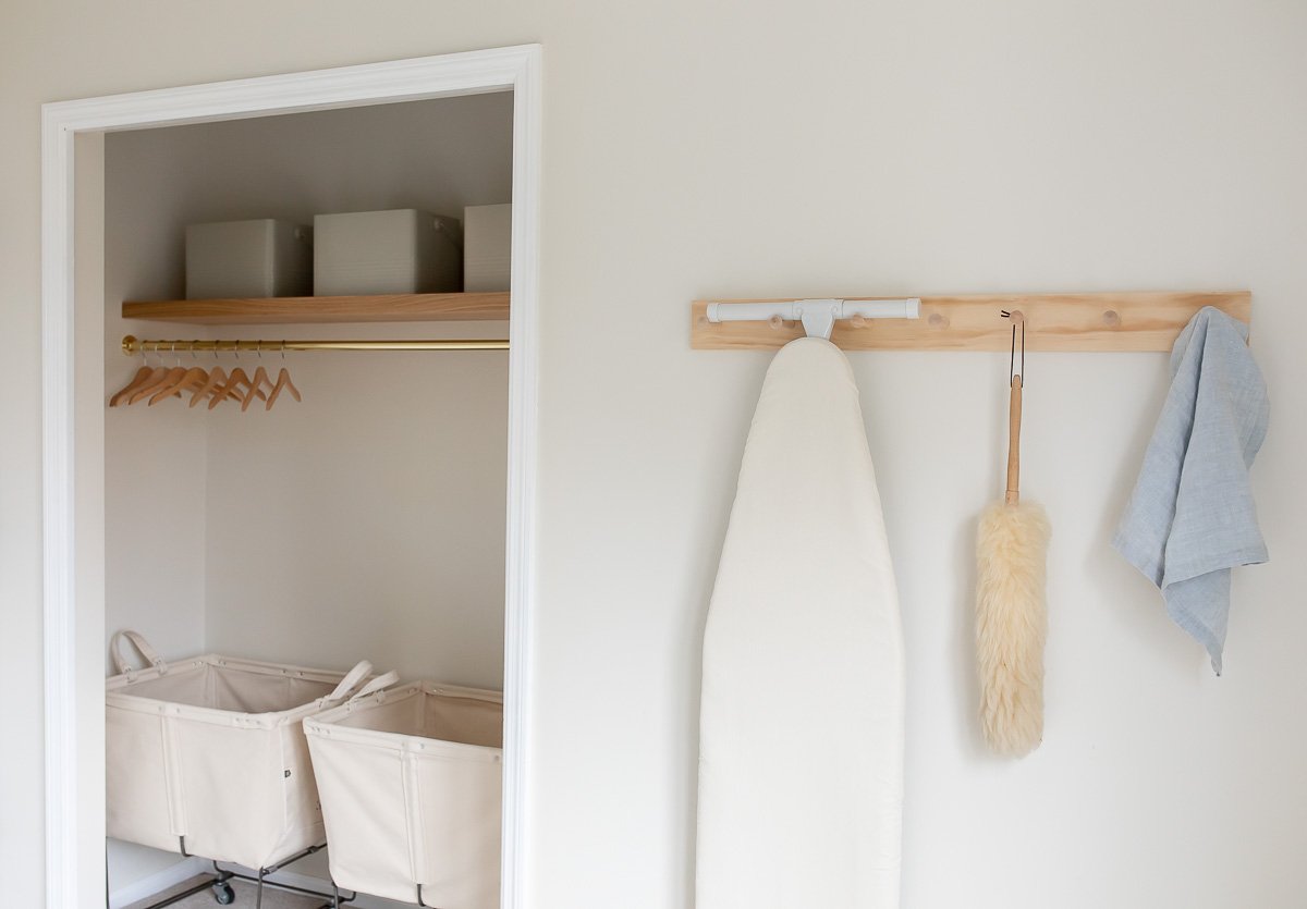 A well-organized laundry room with baskets and towels hanging on the wall.