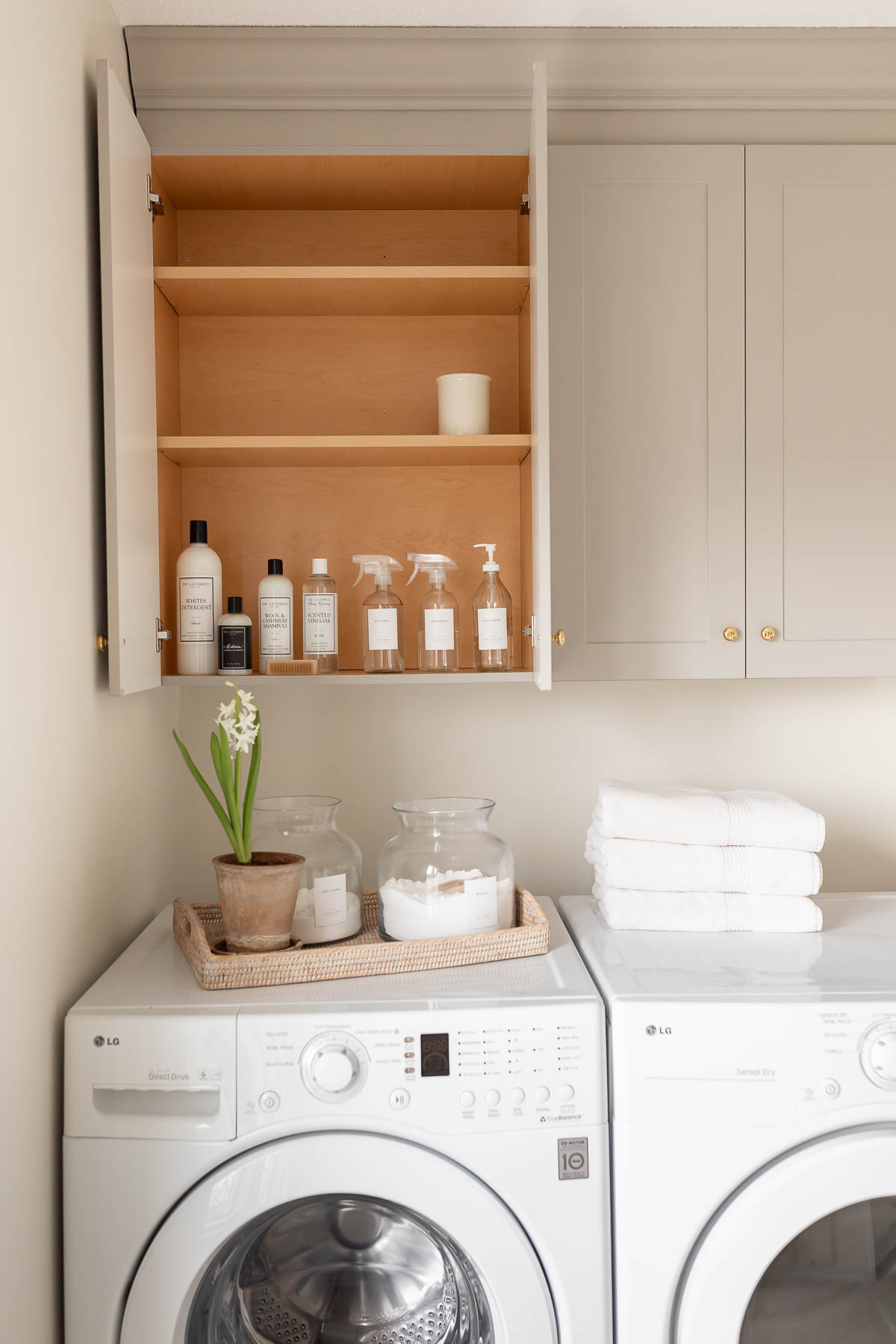 A laundry room with a washer and dryer, designed for efficient laundry room organization.