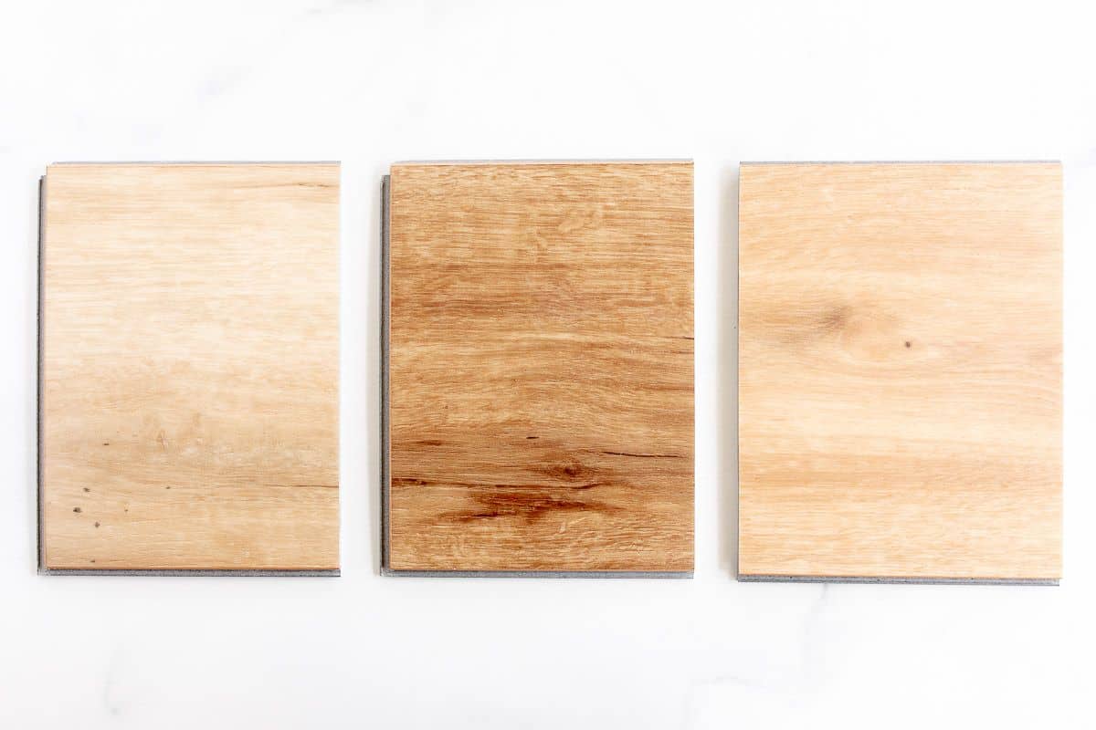 Small samples of the best vinyl plank flooring laid out on a white surface.