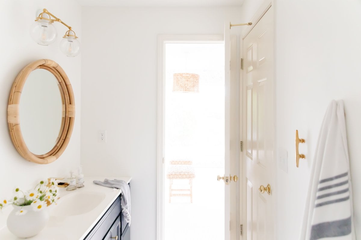 A modern coastal bathroom with boat cleats for hanging towels