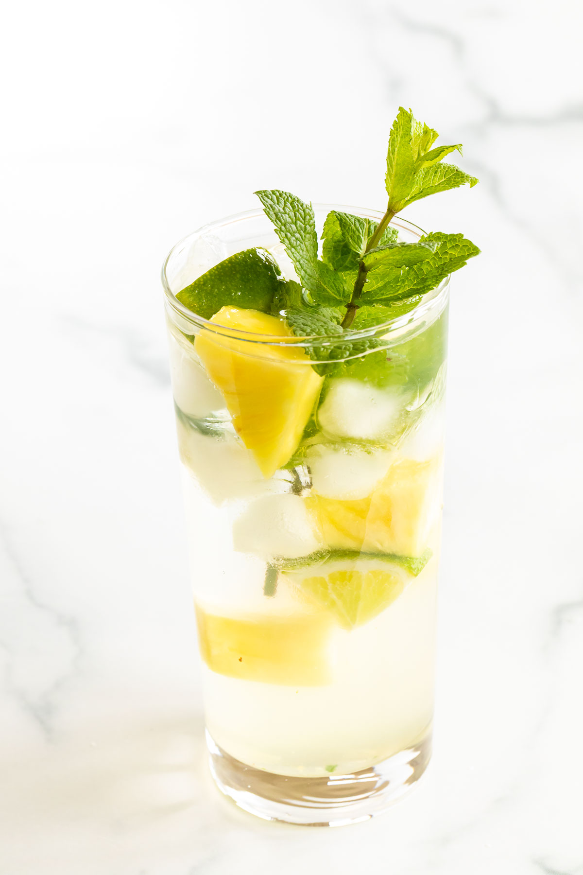 mojito with pineapple and mint in clear glass