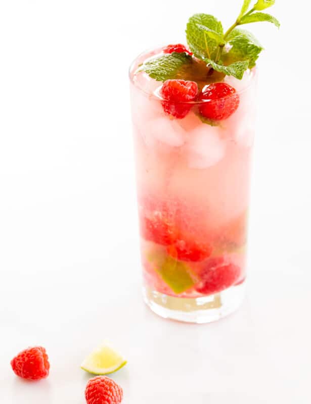 raspberry mojito with limes and mint sprig
