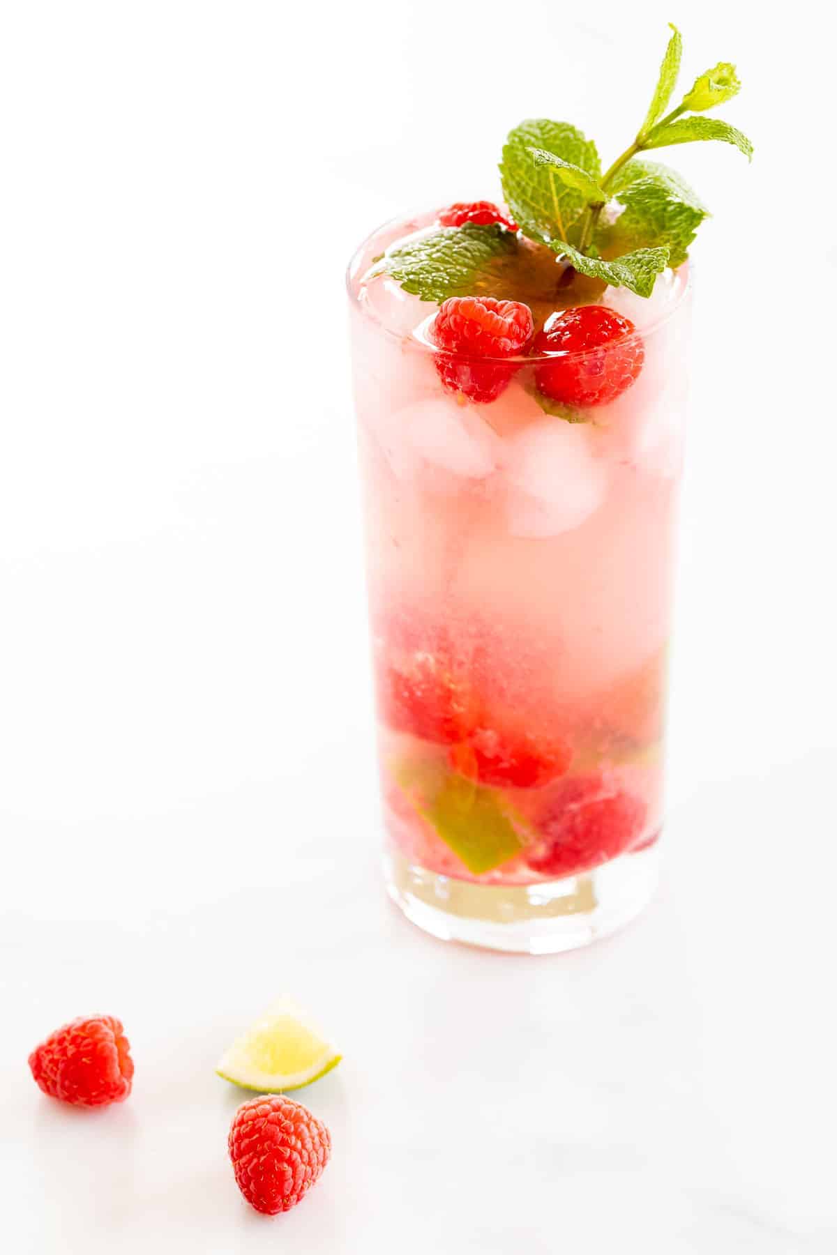 raspberry mojito with limes and mint sprig