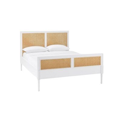 A white rattan bed with wicker headboard and footboard.