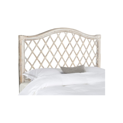 A white rattan bed with a white headboard.