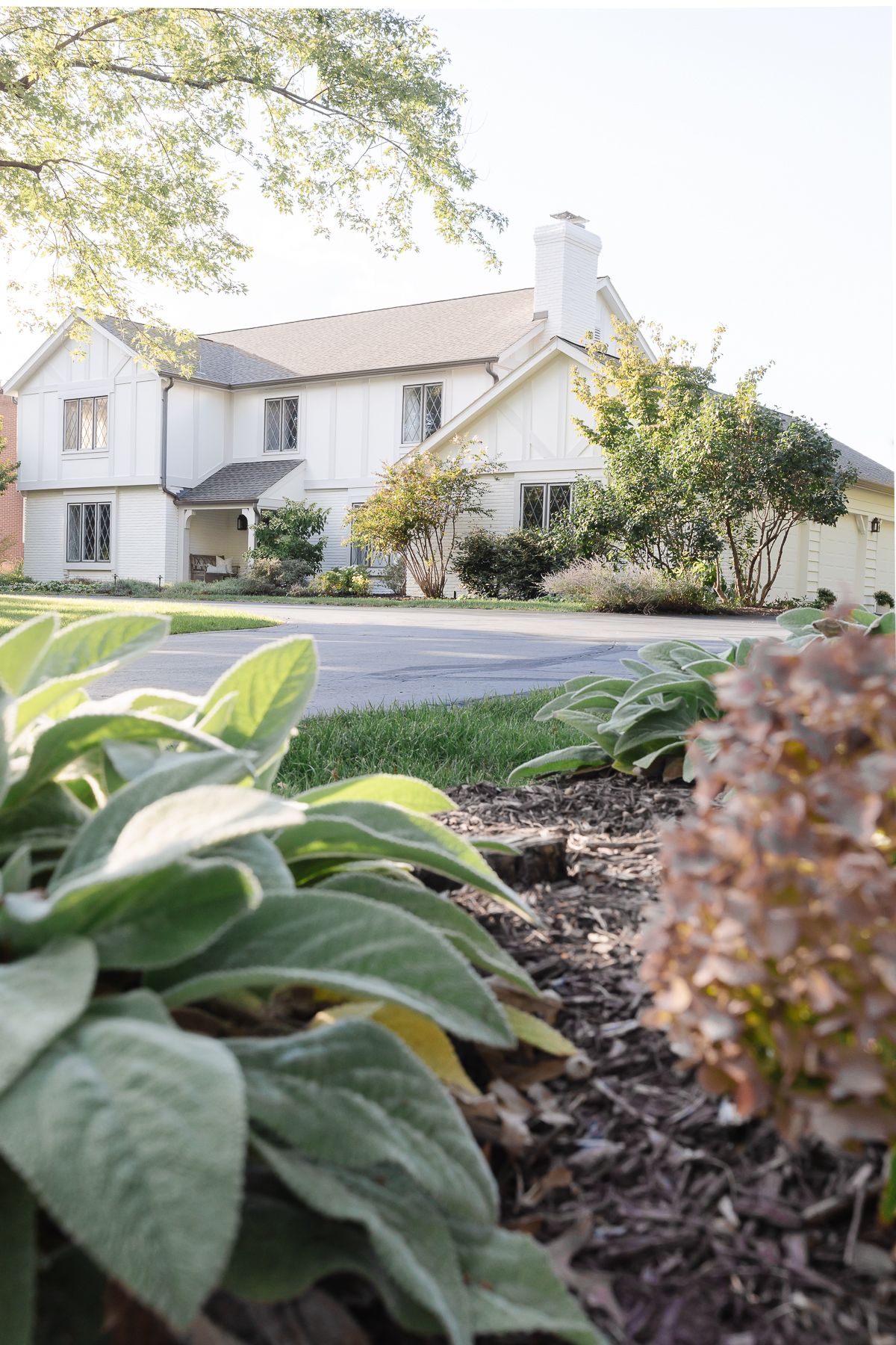 A vintage 70s tudor home, with soft cream and greige tudor paint colors.