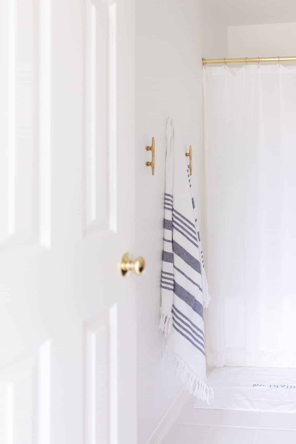 bathroom with brass boat cleat towel hanger