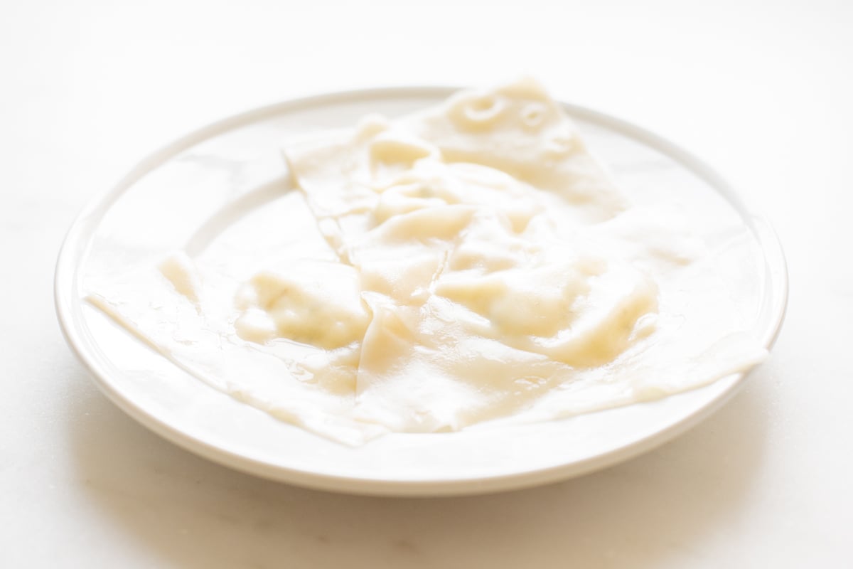 Ravioli on a white plate.