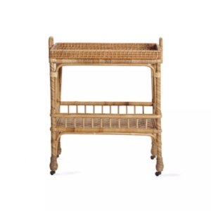 A rattan serving cart on wheels perfect for lake house decor.