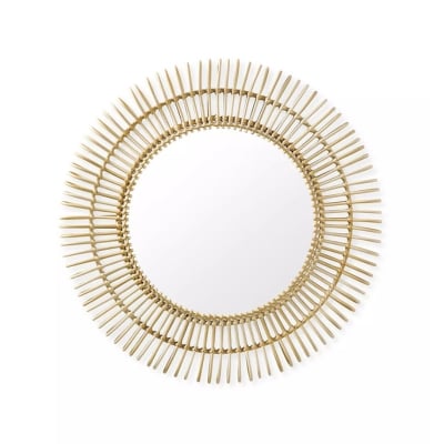 A circular mirror with gold spikes on a white background, perfect for lake house decor.