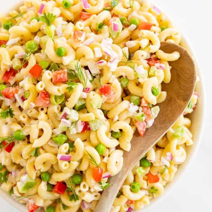 bowl of pasta salad with wood spoon