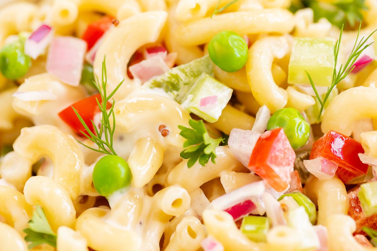 Close up of macaroni salad recipe with fresh vegetables.