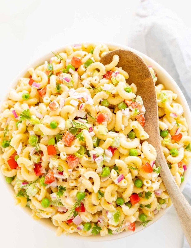A white bowl full of macaroni salad.