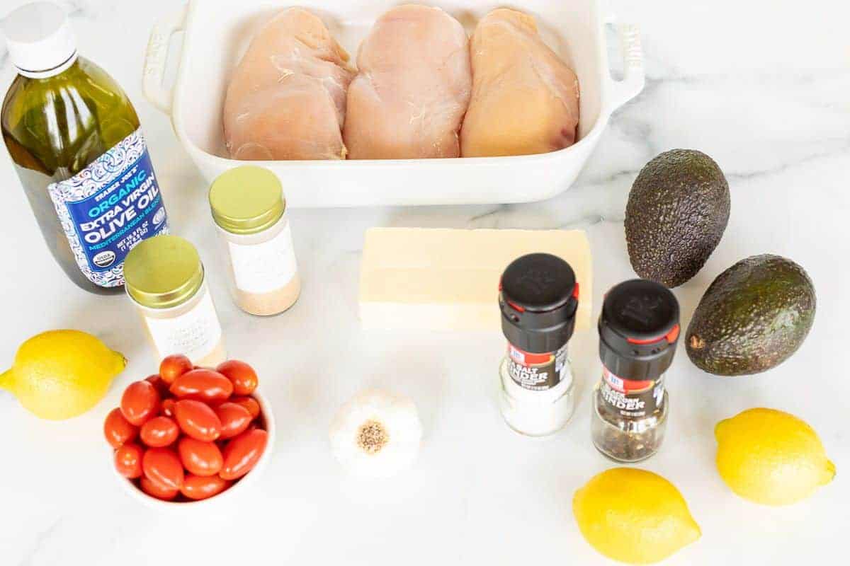Ingredients for California chicken on a white marble surface.